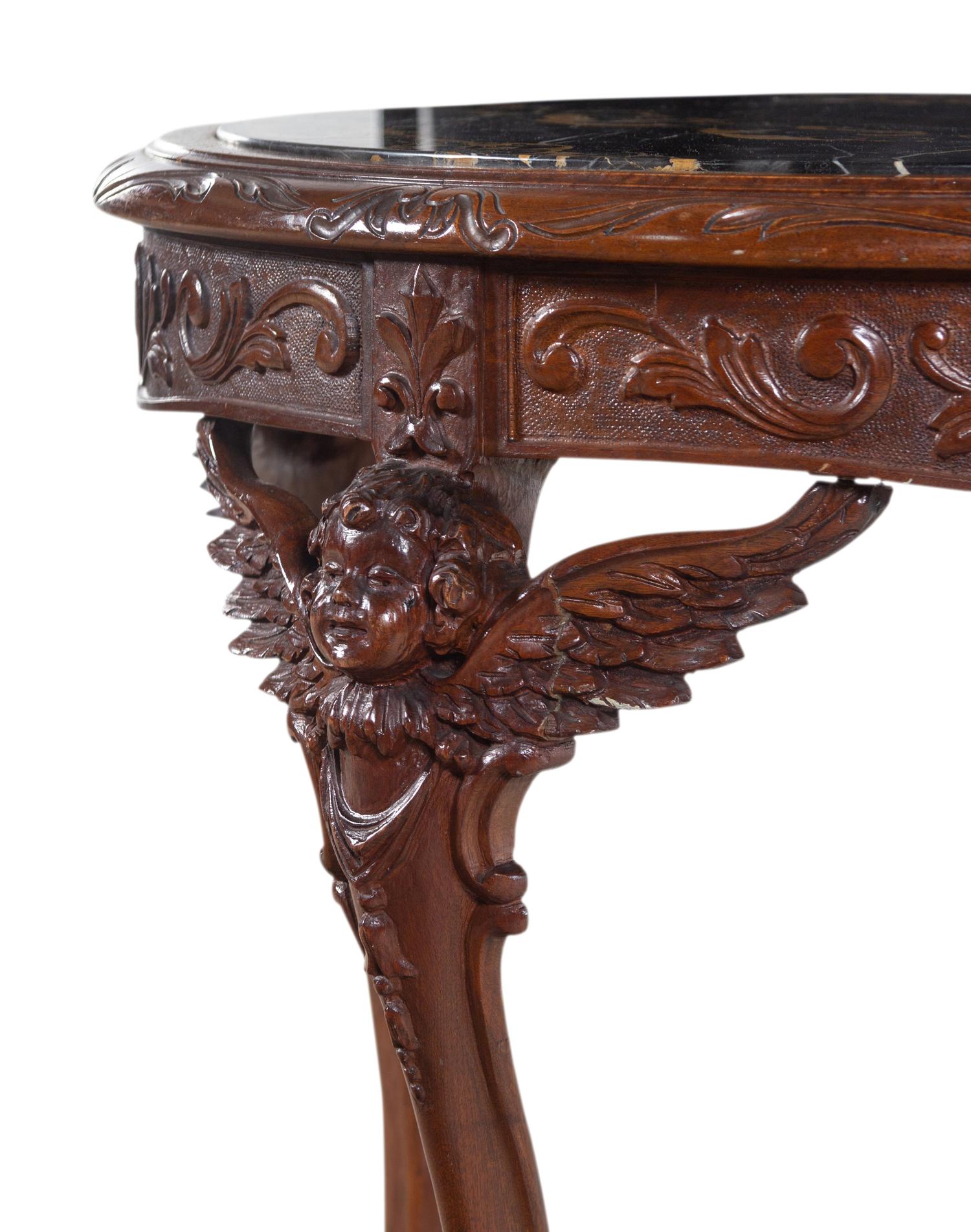 An Italian Carved Walnut Marble-Top Center Table