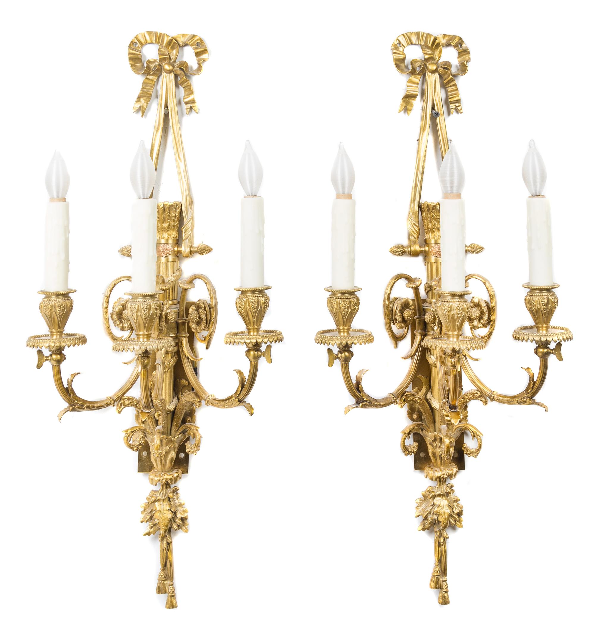 A Pair of Louis XVI Style Gilt Bronze Three-Light Sconces Length 27 inches. — LATE 20TH CENTURY