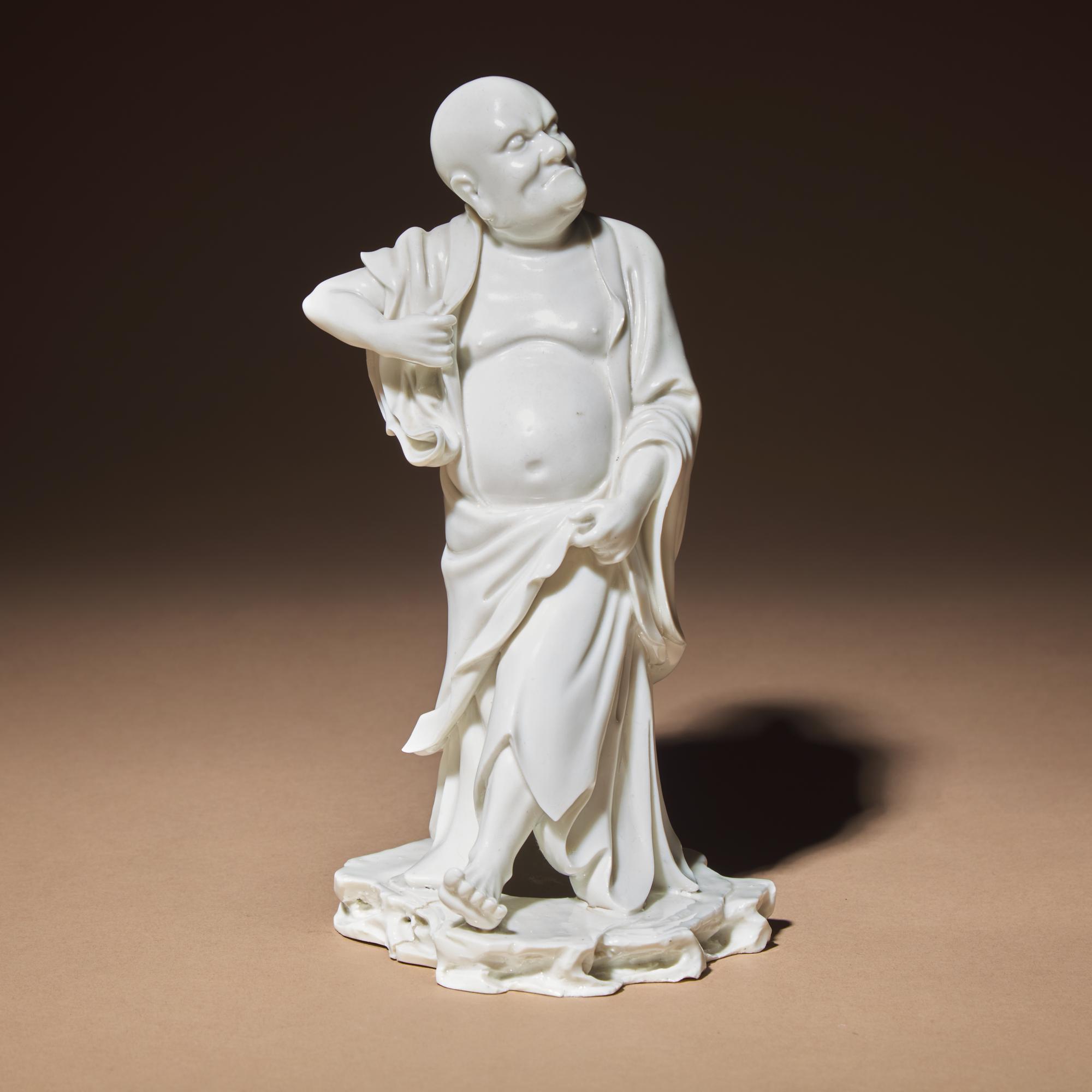 A Chinese Blanc-de-Chine Porcelain Standing Figure of a Luohan, Qing Dynasty — 清 德化白瓷羅漢立像