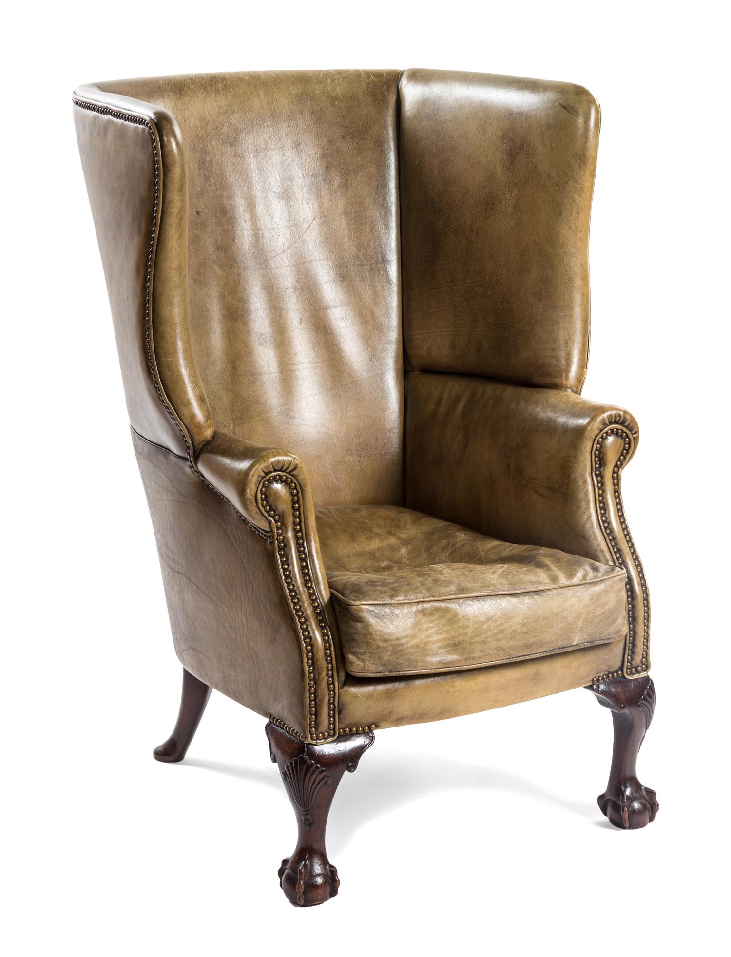 A Chippendale Style Leather Wingback Armchair, POSSIBLY IRISH, EARLY 20TH CENTURY, Height 44 inches. — PROBABLY IRISH, EARLY 20TH CENTURY,