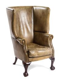 A Chippendale Style Leather Wingback Armchair, POSSIBLY IRISH, EARLY 20TH CENTURY, Height 44 inches. — PROBABLY IRISH, EARLY 20TH CENTURY,