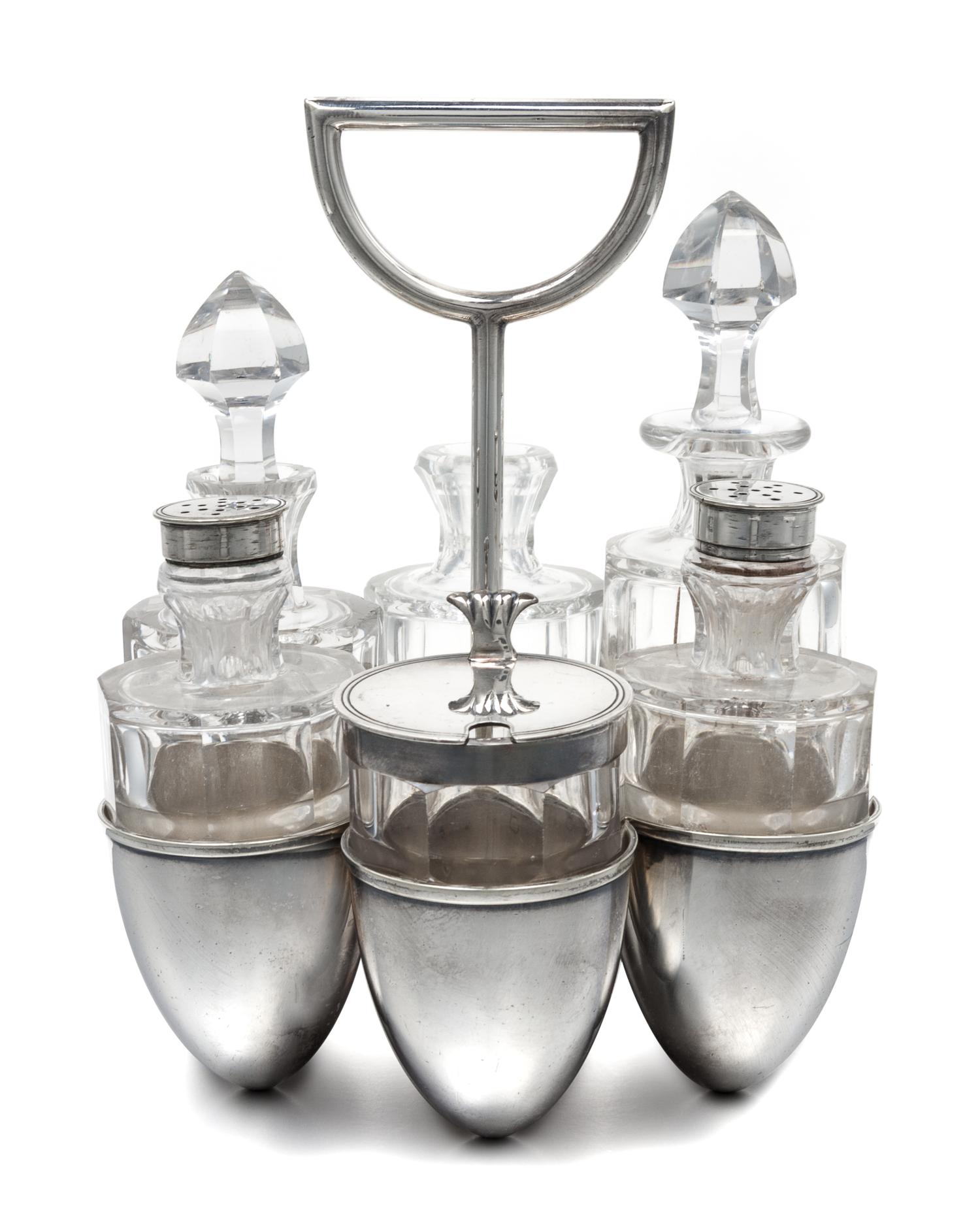 An English Silver-Plate Cruet Set, Dr. Christopher Dresser for Hukin & Heath, Birmingham, the caddy having six egg-form cups and a cent