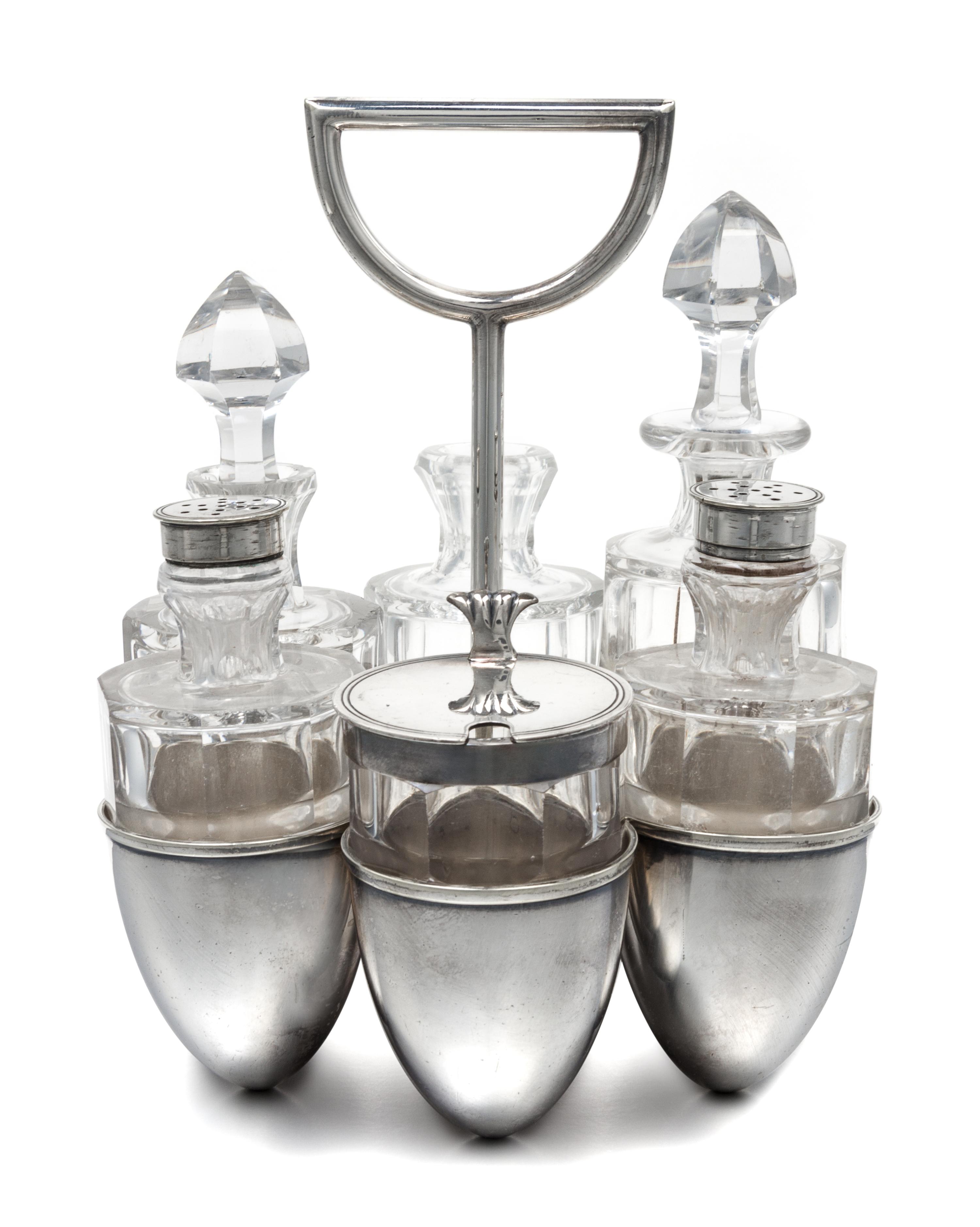 An English Silver-Plate Cruet Set, Dr. Christopher Dresser for Hukin & Heath, Birmingham, the caddy having six egg-form cups and a cent