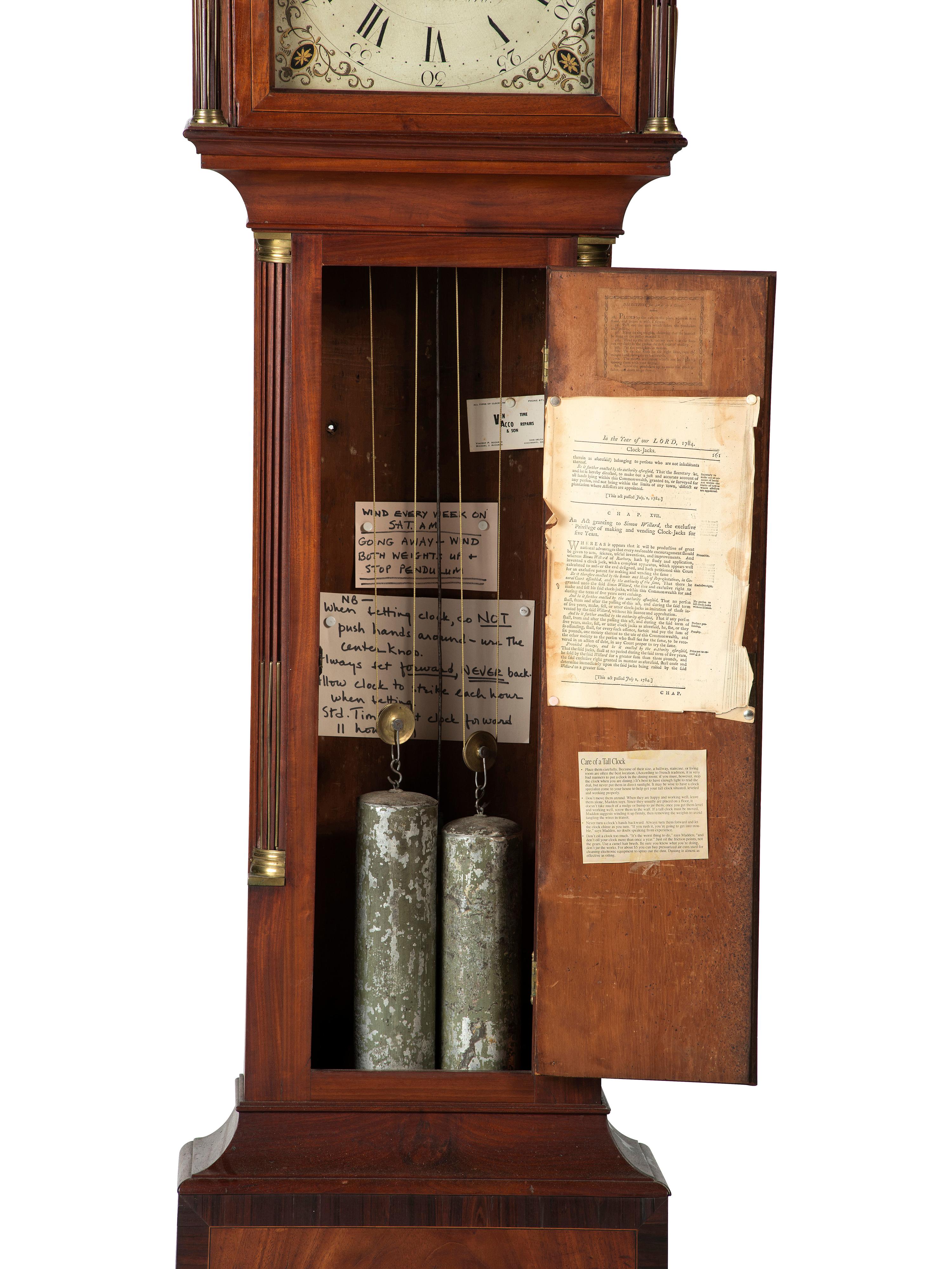 A Federal Carved and Inlaid, Brass-Mounted Mahogany Tall Case Clock