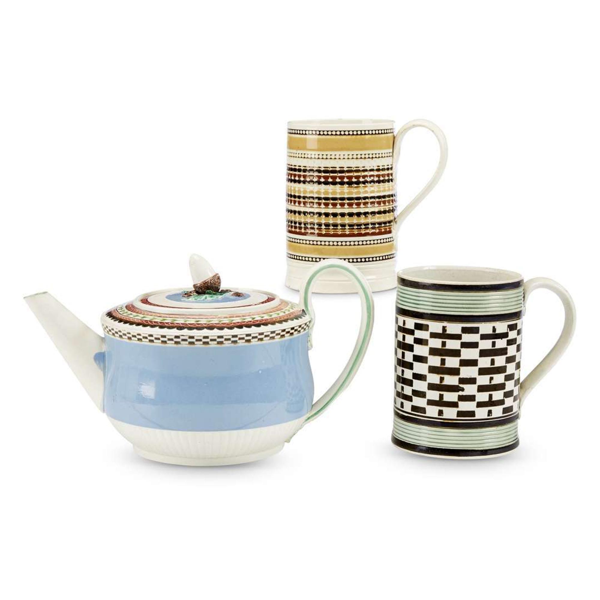 Two turned, incised and slip-decorated Mochaware mugs England, early 19th century