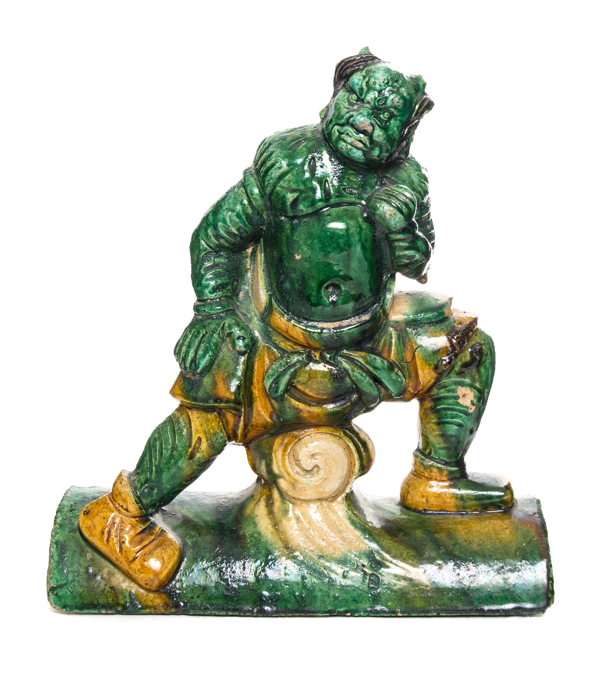 A Sancai Glazed Pottery Figural Roof Tile Height 12 inches.