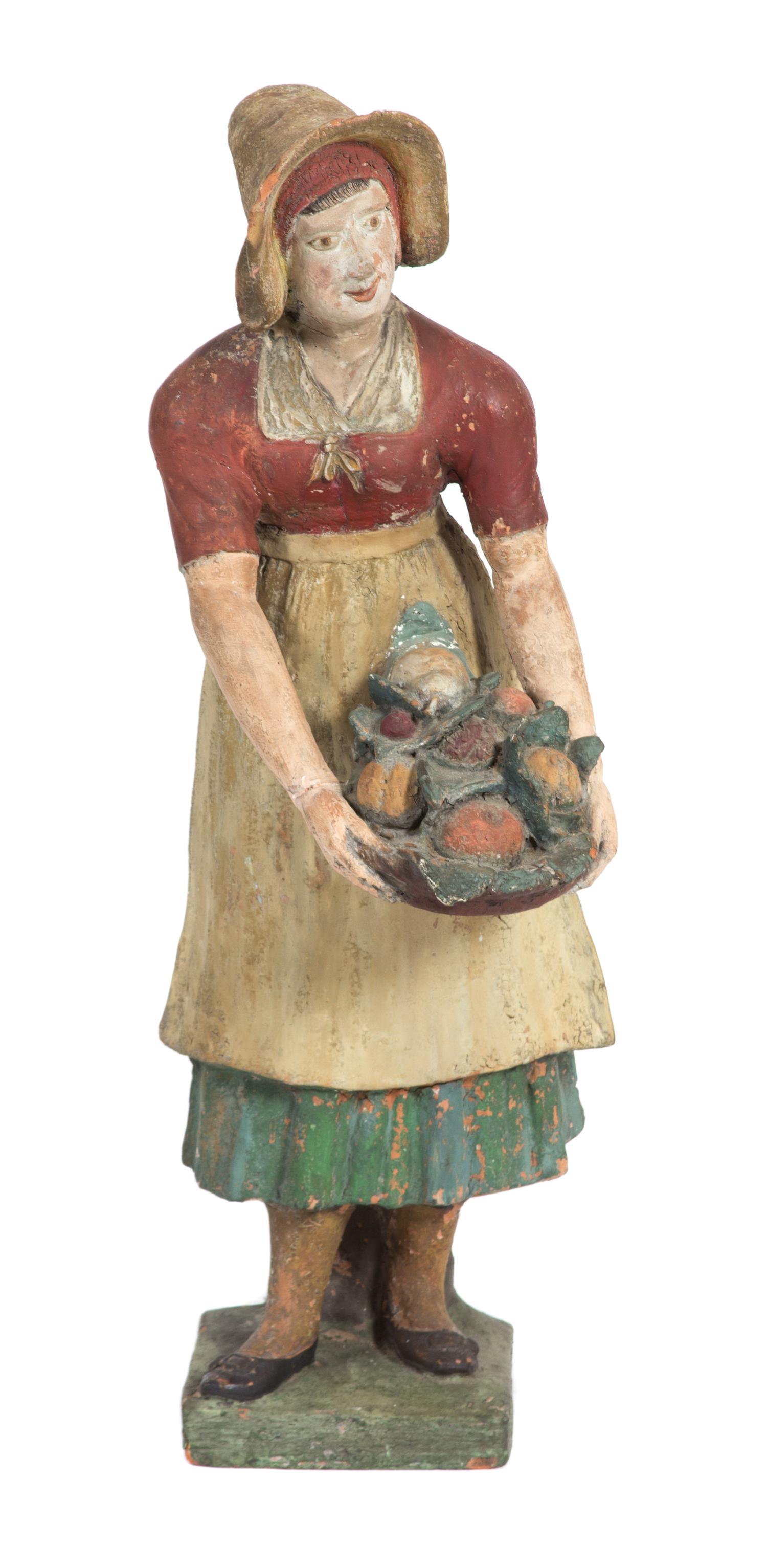 A Polychrome Terracotta Figure of a Woman Height 30 inches.