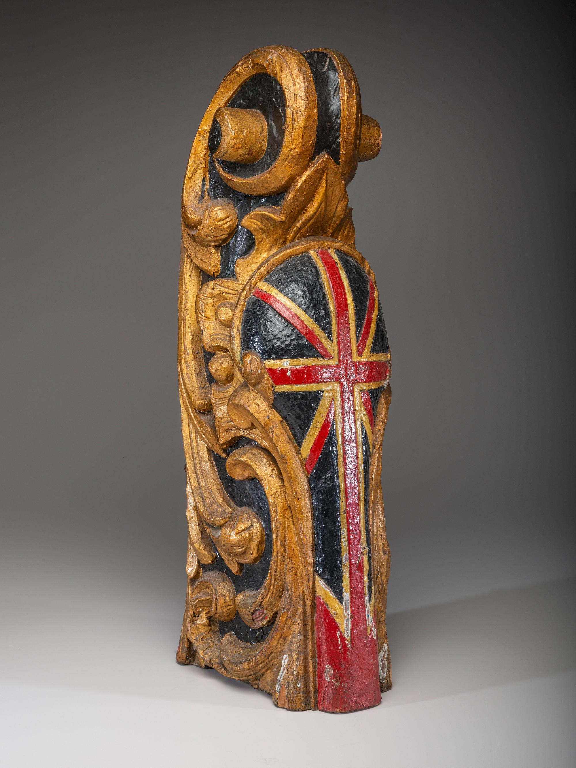 A Carved and Parcel Gilt Union Jack Mast Head