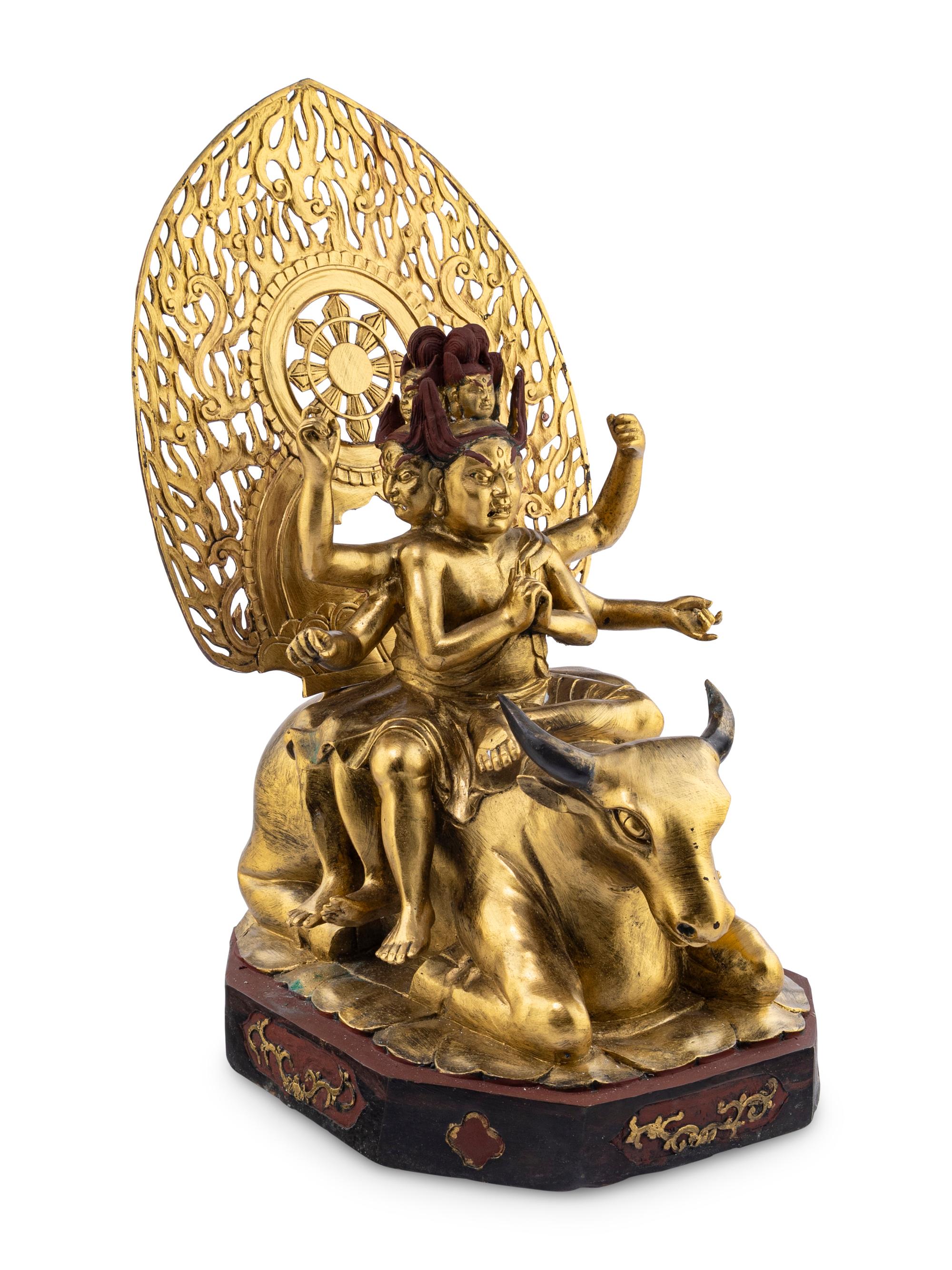 A Gilt and Red Lacquered Bronze Figure of a Multi-Armed Deity
