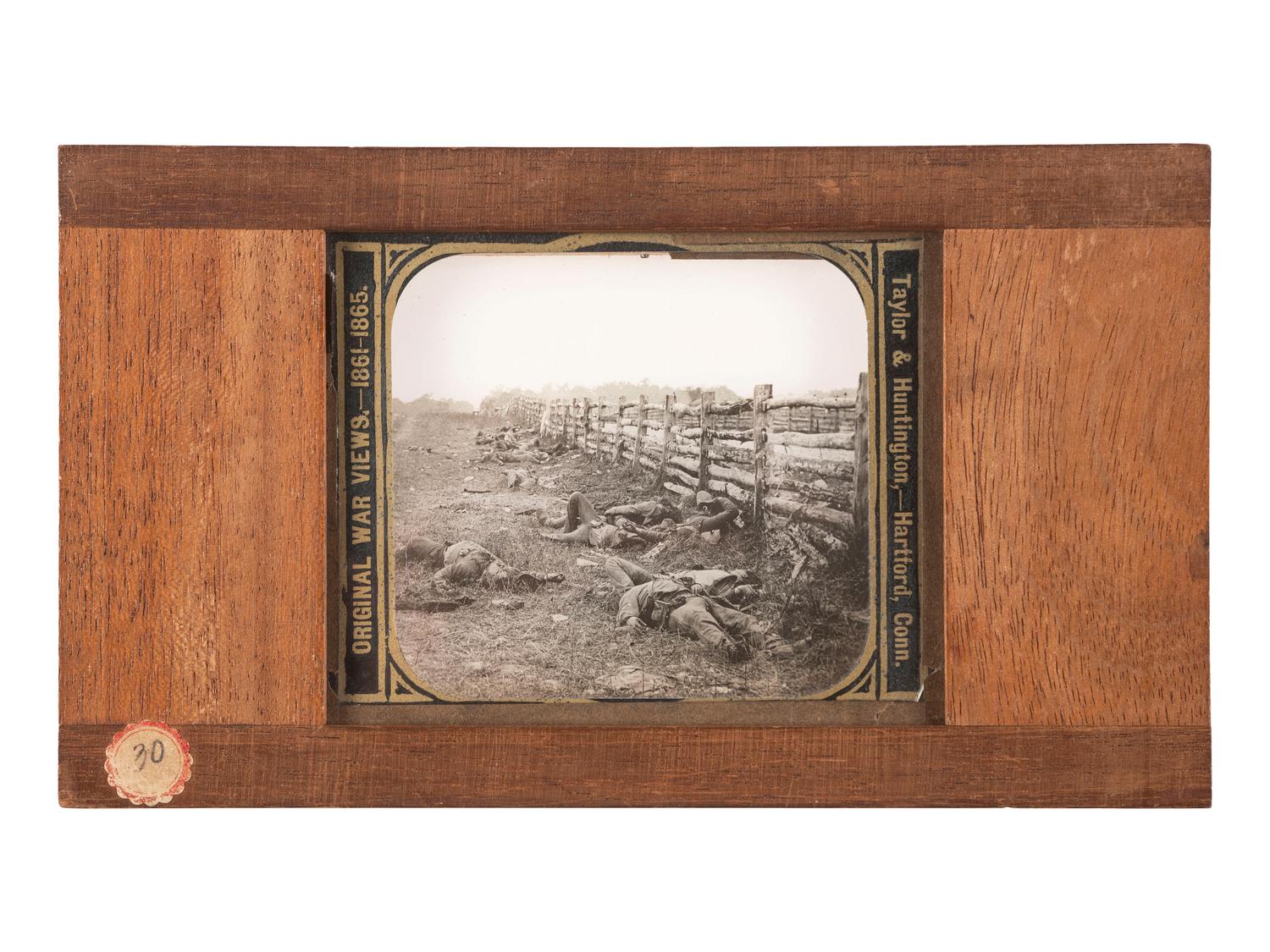 [CIVIL WAR]. GARDNER, Alexander, photographer. A group of 2 images of fallen Confederate soldiers at Antietam, including stereoview and magic lantern slide. Hartford, CT: Taylor & Huntington.