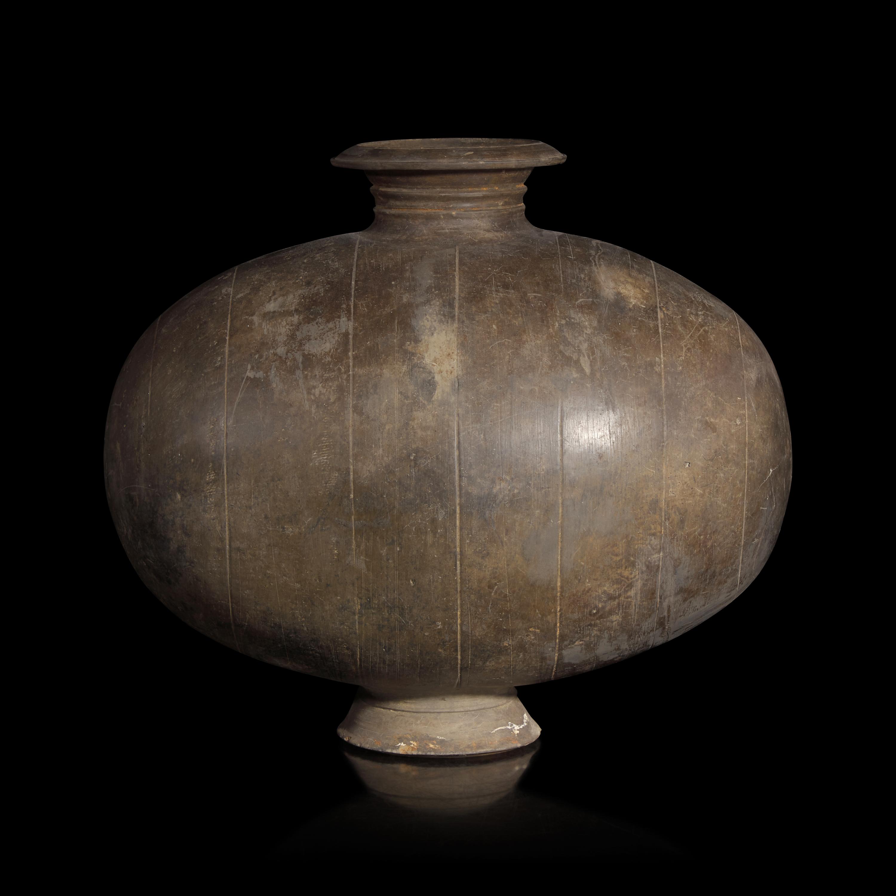 A Chinese Grey Pottery Cocoon Jar, Han Dynasty — 漢 灰陶繭形罐