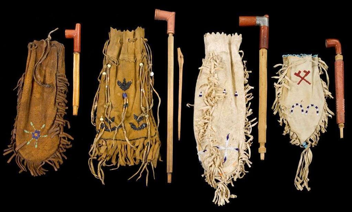 Four small beaded hide pipe bags with pipes first half 20th century