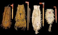 Four small beaded hide pipe bags with pipes first half 20th century