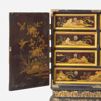 A Chinese Export gilt-decorated black lacquer table cabinet on a George I gilt-decorated and ebonized stand 18th century