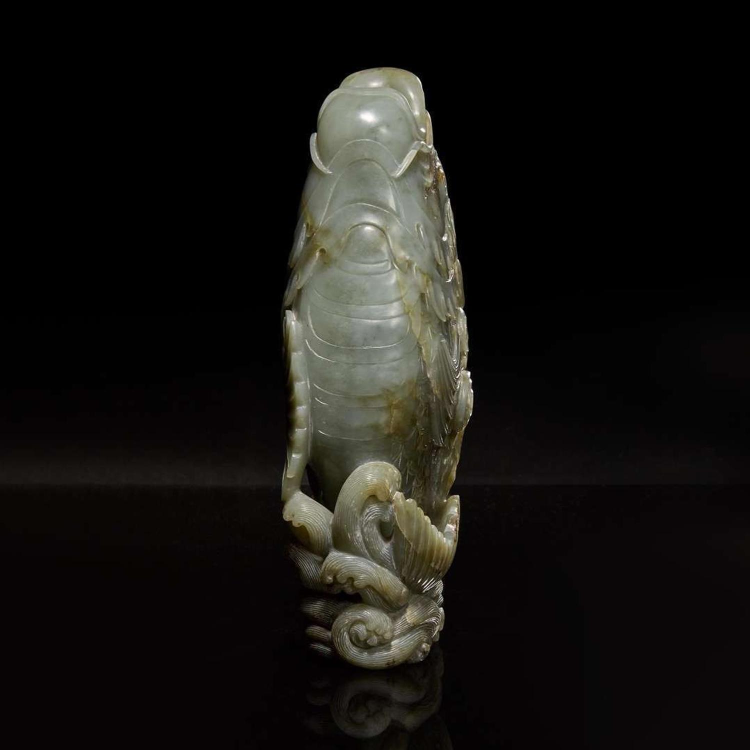 A Chinese carved celadon jade figure of a leaping carp 青玉鯉躍龍門花插