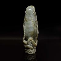 A Chinese carved celadon jade figure of a leaping carp 青玉鯉躍龍門花插
