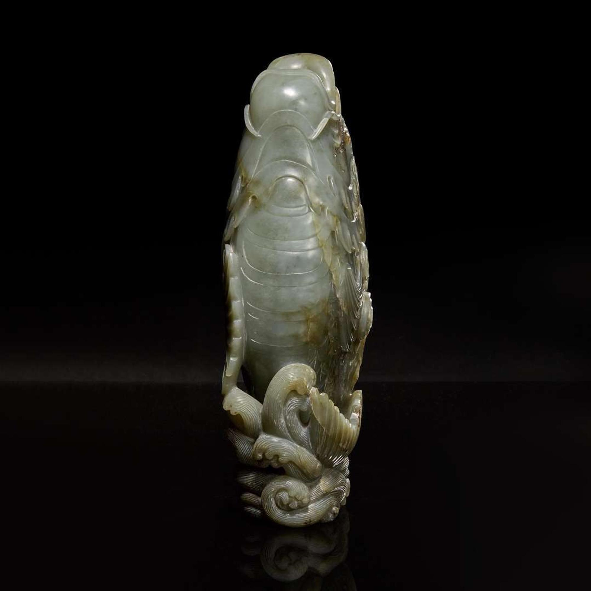 A Chinese carved celadon jade figure of a leaping carp 青玉鯉躍龍門花插