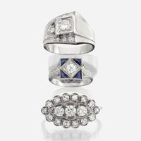 A collection of three white gold and diamond rings