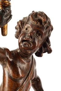A Pair of Continental Carved Walnut Figures of Putti