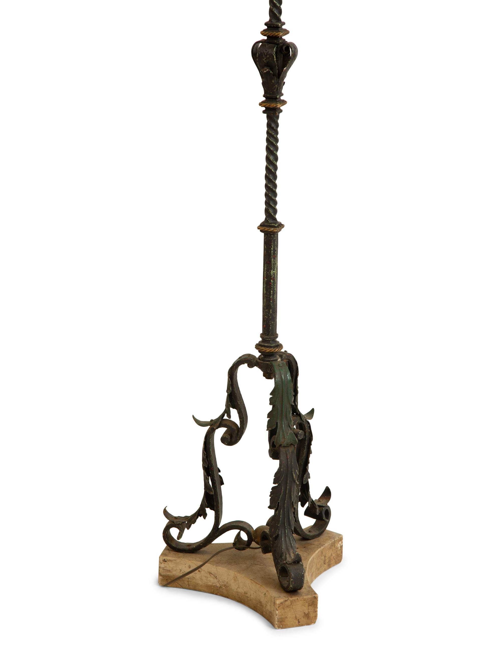 A Mizner Style Painted and Parcel Gilt Wrought Iron Four-Light Torchère with Polychromed Leather Shade