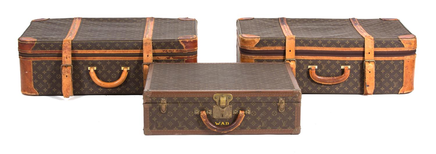 A Group of Three Louis Vuitton Suitcases Largest height 22 x width 30 x depth 10 inches. Hard case 16 x width 24 x depth 6 3/4 inches. — 20TH CENTURY