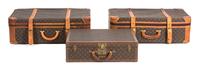 A Group of Three Louis Vuitton Suitcases Largest height 22 x width 30 x depth 10 inches. Hard case 16 x width 24 x depth 6 3/4 inches. — 20TH CENTURY