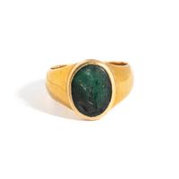 A Roman Gold and Plasma Finger Ring with a Figure Holding Tools and an Inscription