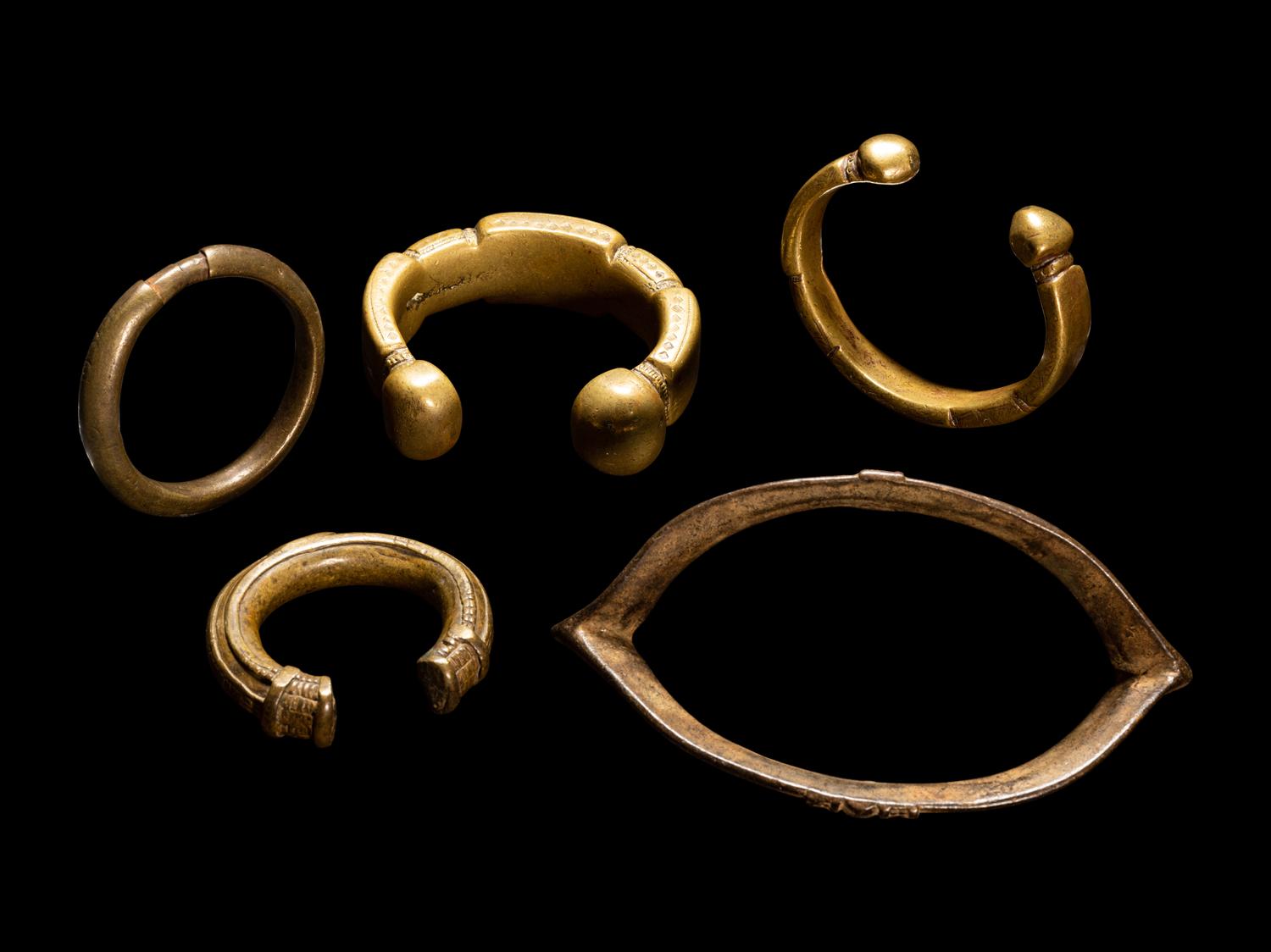 Five African Metalwork Currency Bracelets