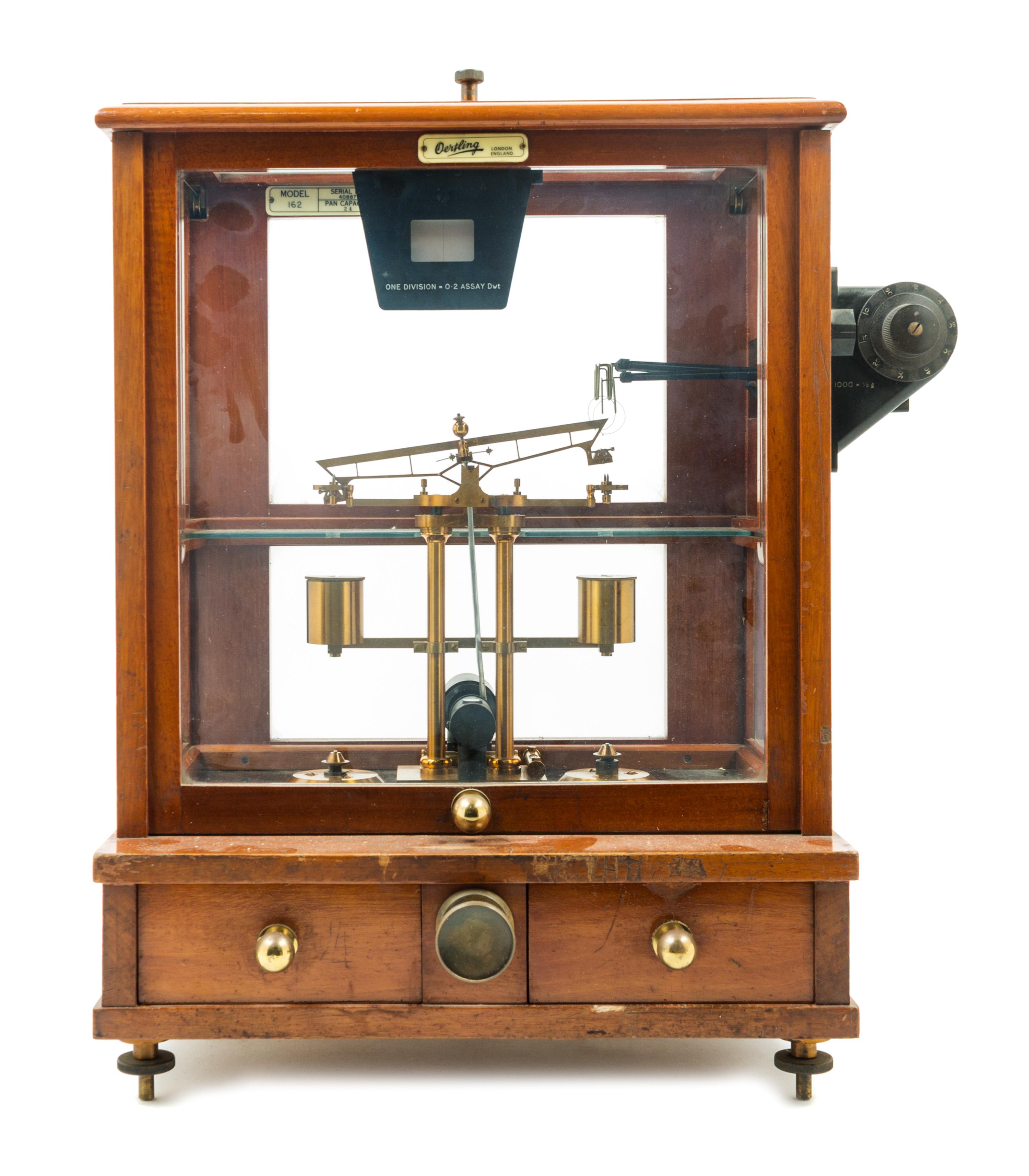 An English Mahogany Cased Brass Assayer's Balance Height of case 19 1/2 x width 14 1/2 x depth 10 1/2 inches. — L. OERTLING, LONDON, 20TH CENTURY