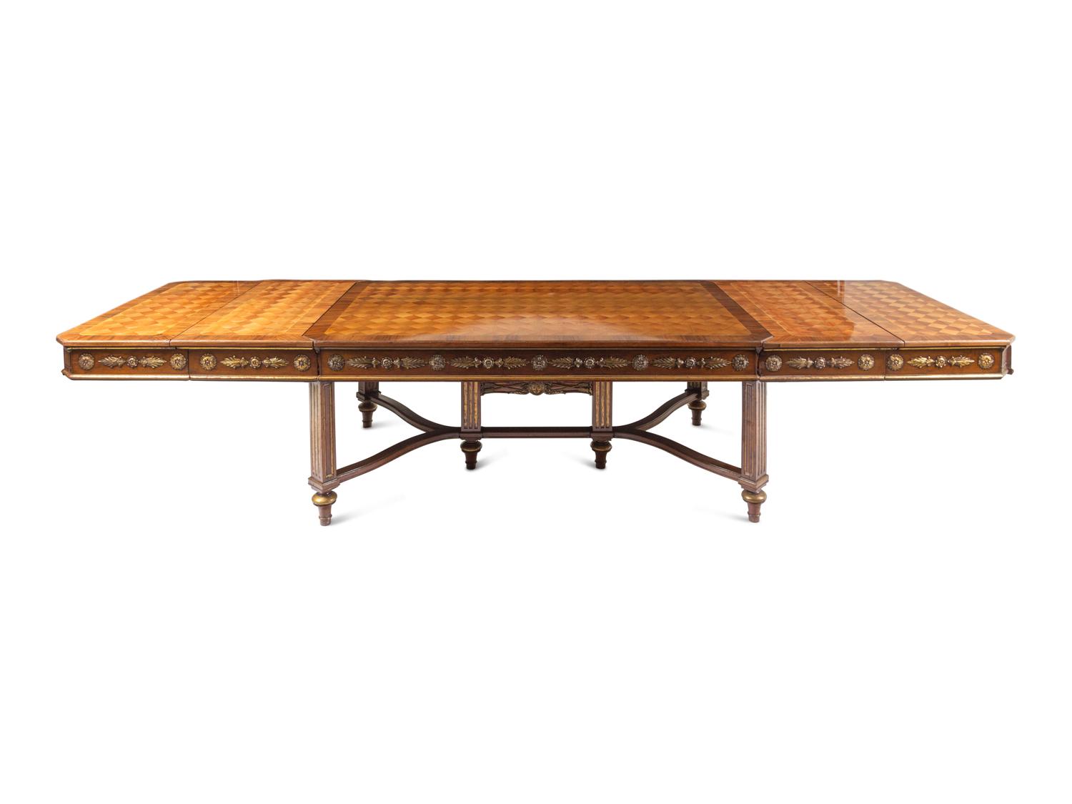A Louis XVI Style Parcel Gilt Parquetry and Walnut Dining Table