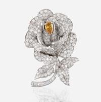 A diamond, yellow diamond, and platinum rose brooch