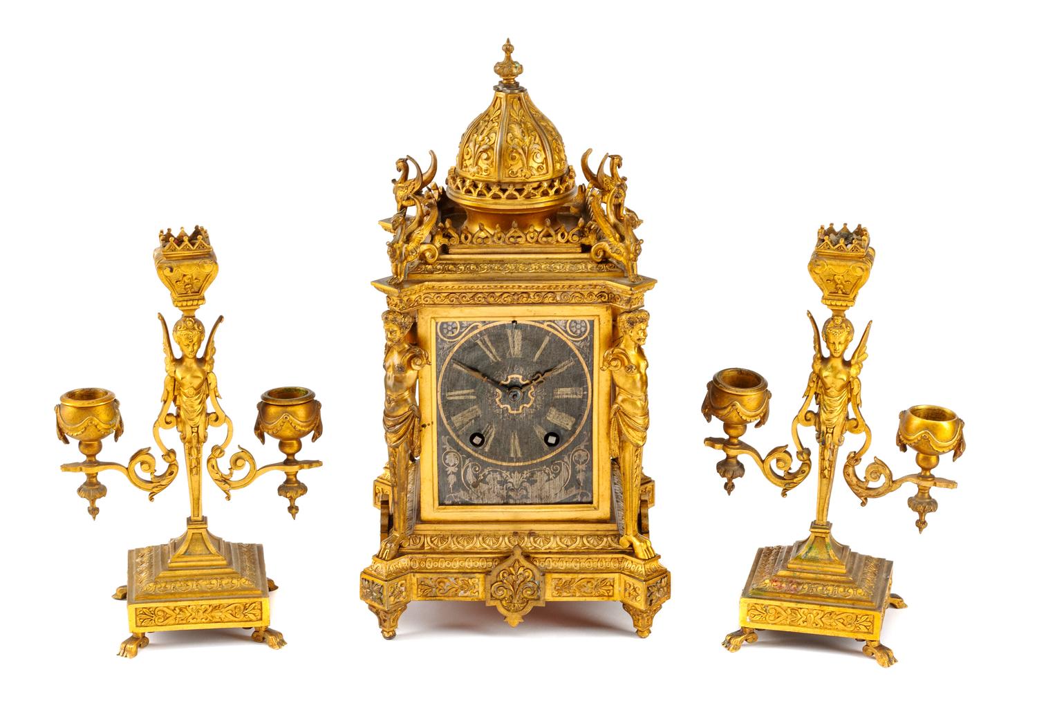 A Neoclassical Silvered and Gilt Bronze Three-Piece Clock Garniture