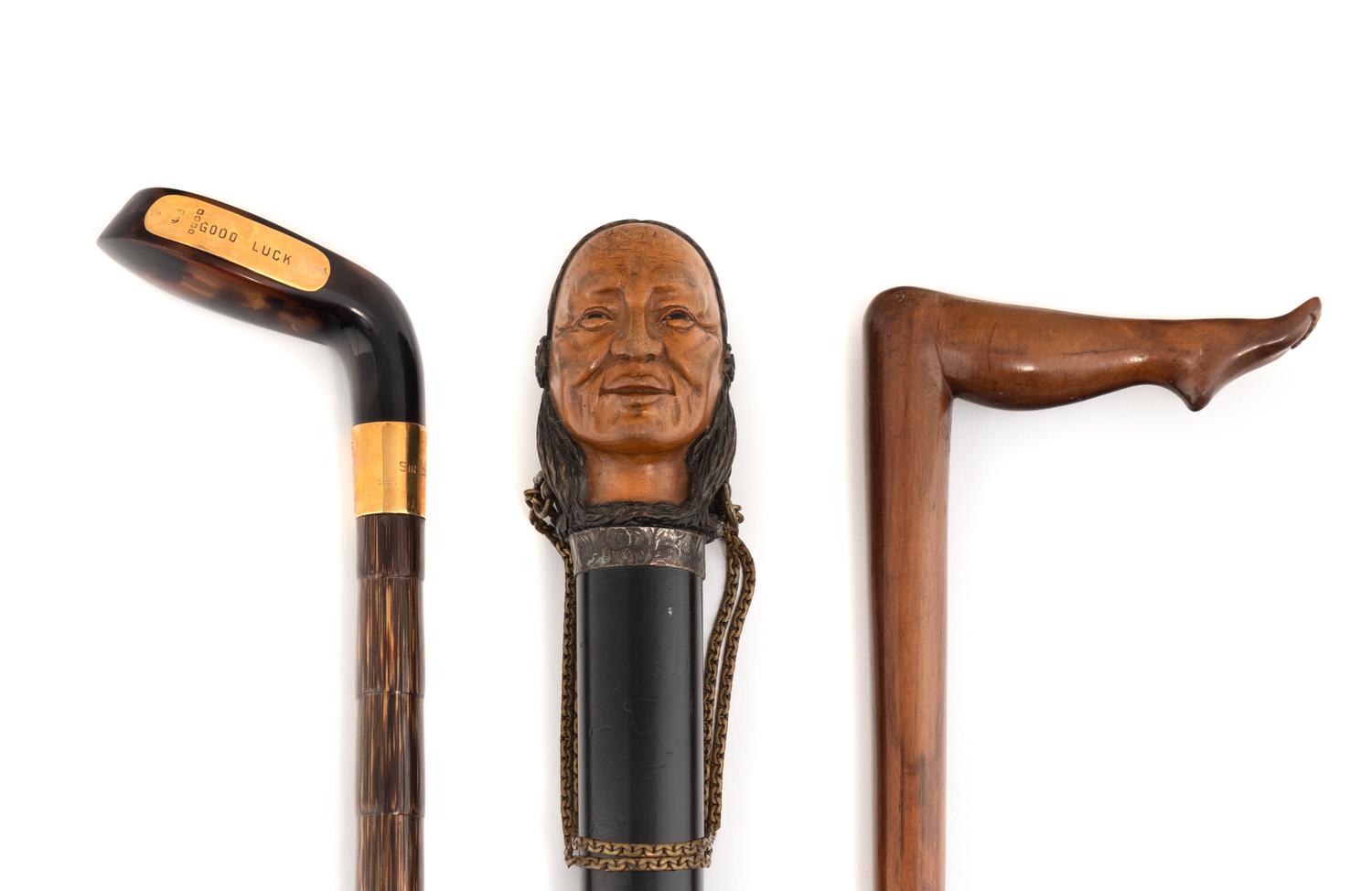 A Group of Three Carved Wood and Tortoise Shell Walking Sticks