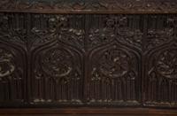 A Gothic Revival Carved Oak Tile-Mounted Chest on Stand