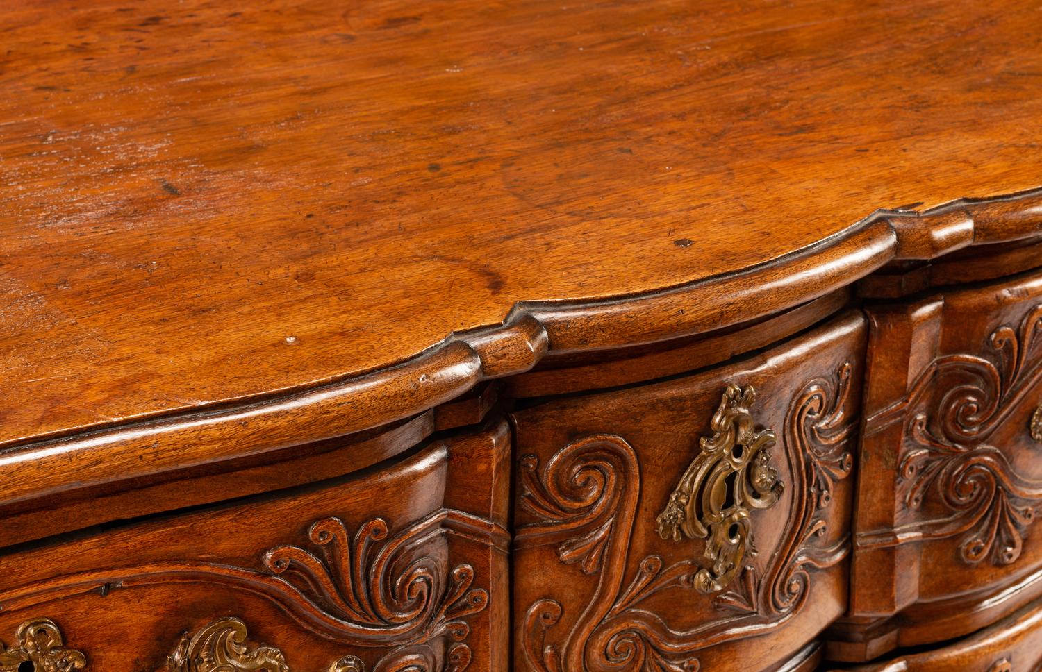 A Louis XV Provincial Carved Walnut Commode