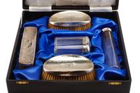 An Edwardian Silver Mounted Five-Piece Dresser Set, H. Matthews, Birmingham, 1902 and Others, comprising three brushes and two silver-m