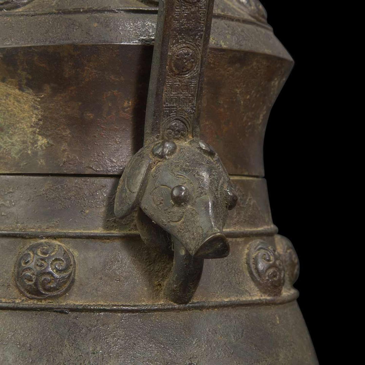 A Chinese patinated bronze archaistic vessel and cover, you 复古风格铜提梁卣