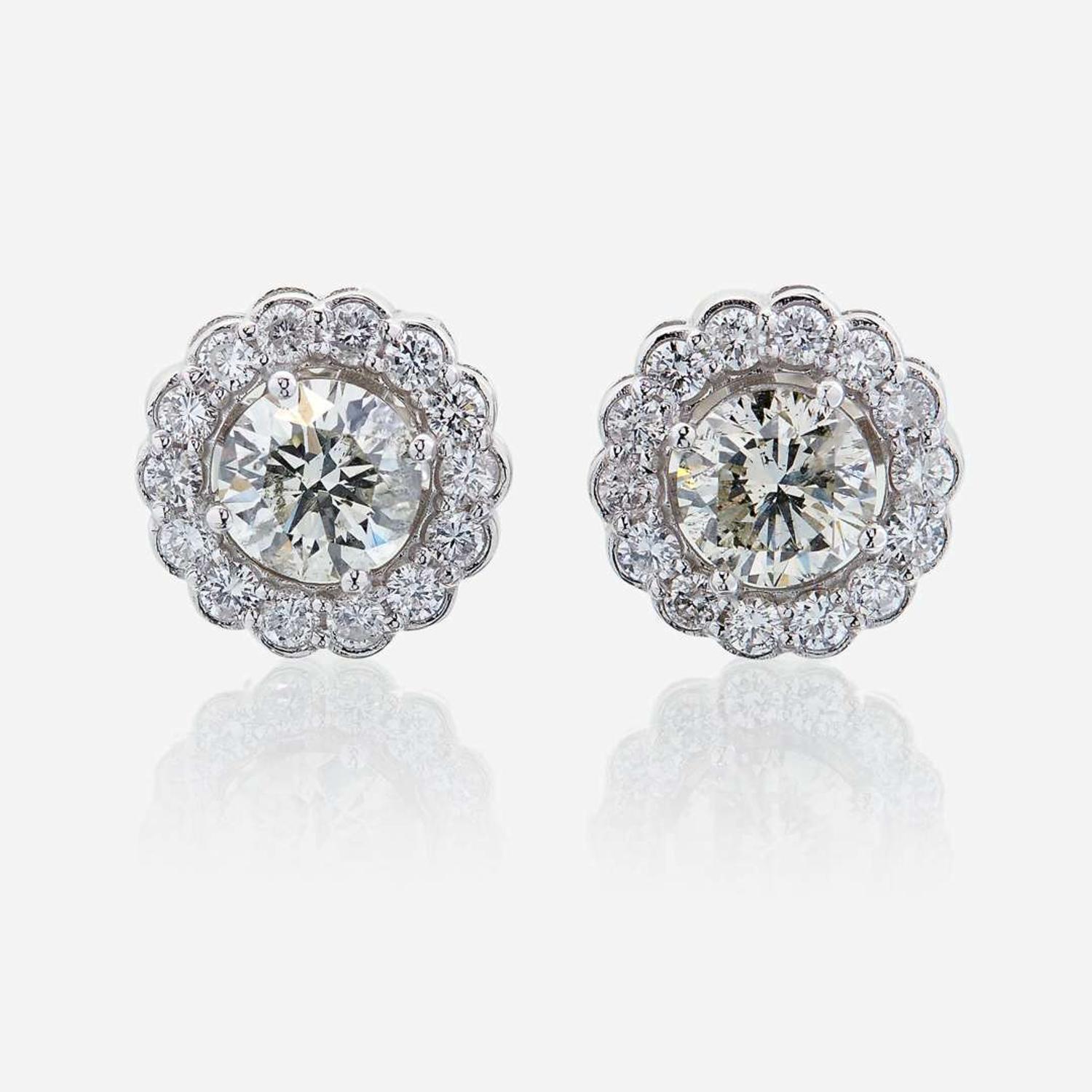 A pair of diamond and eighteen karat white gold earrings