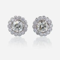 A pair of diamond and eighteen karat white gold earrings
