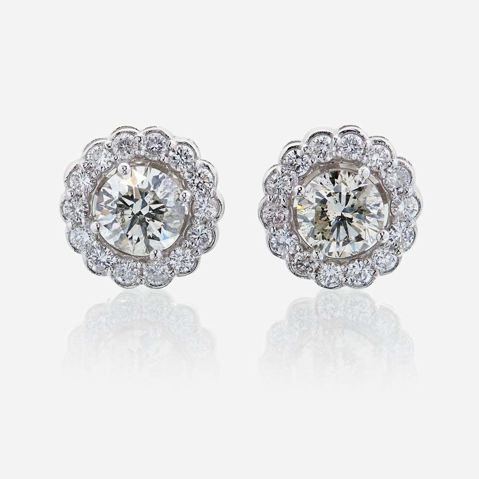 A pair of diamond and eighteen karat white gold earrings