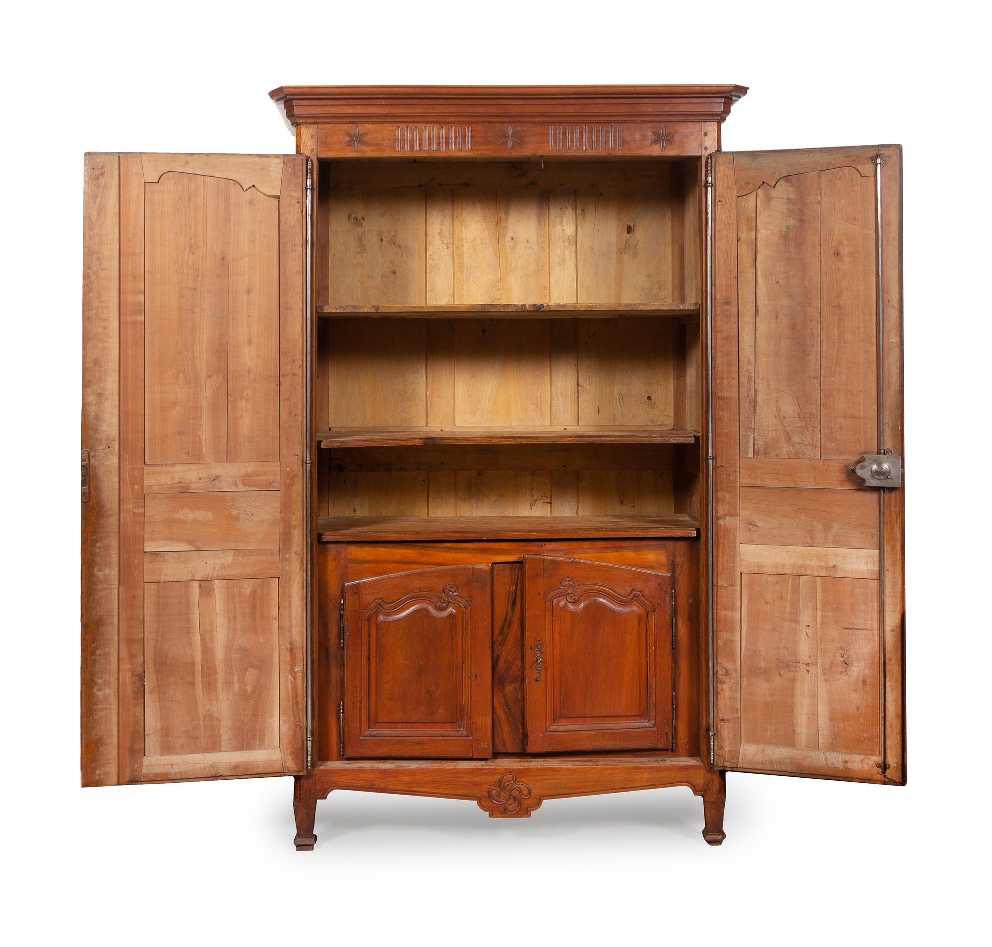 A French Provincial Carved Walnut Armoire