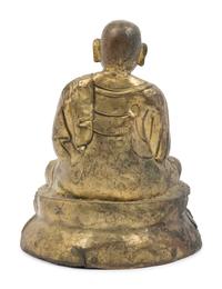 A Large Tibetan Parcel Gilt Bronze Repoussé Figure of a Seated Monk