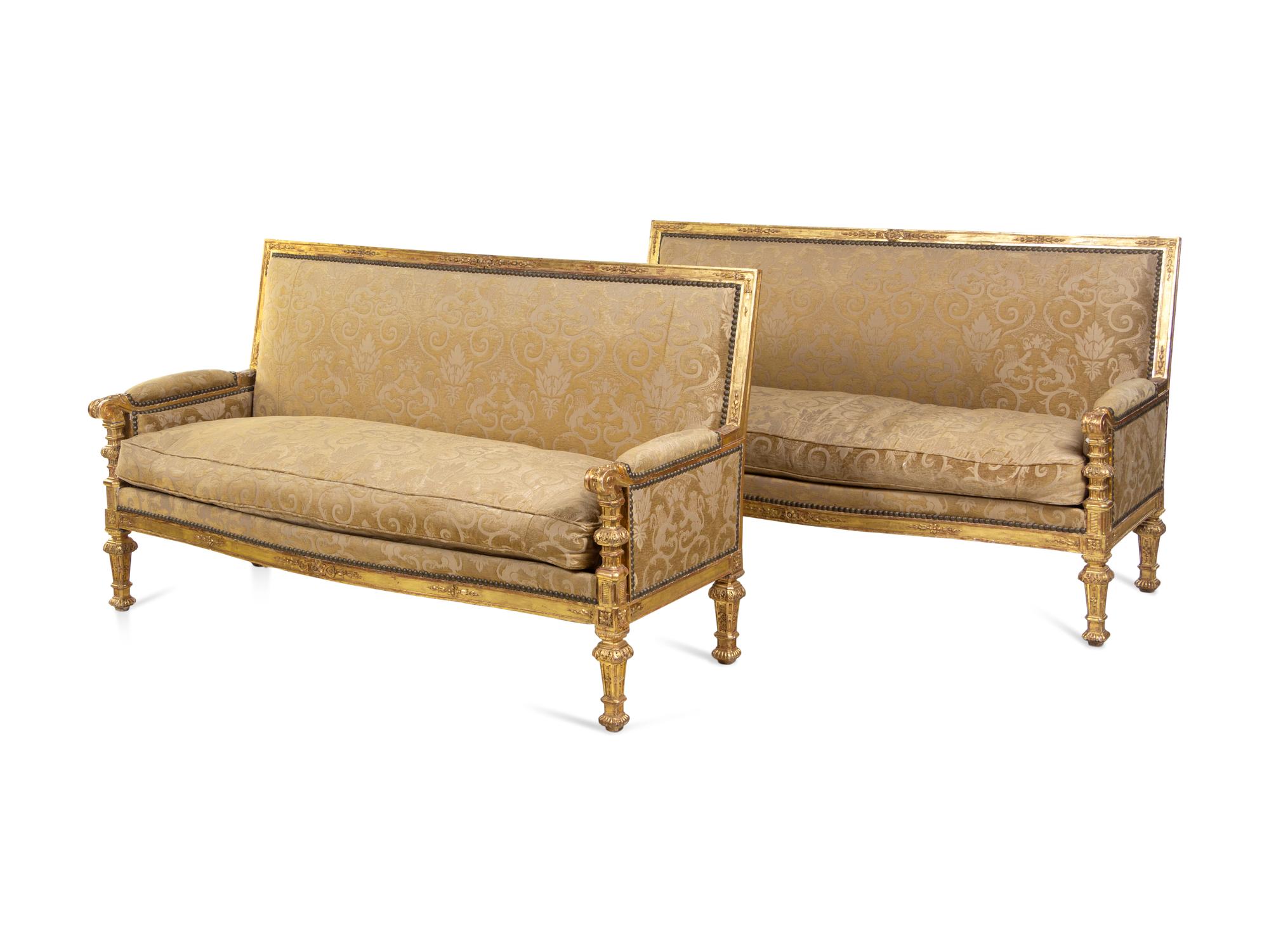 A Pair of Régence Style Carved Giltwood Sofas
