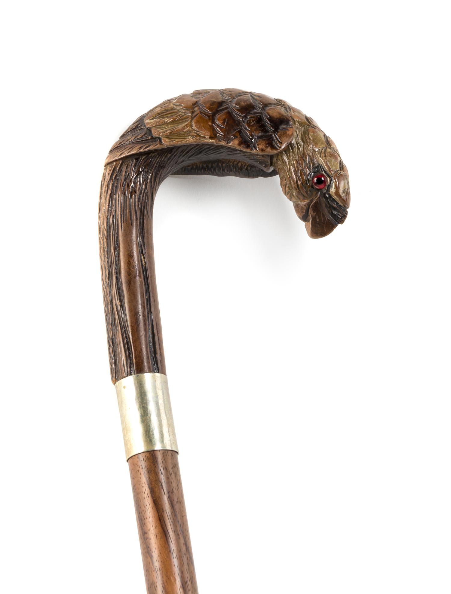 A Carved Wood Cane, Length of handle 5 1/4 x length overall 35 3/4 inches.