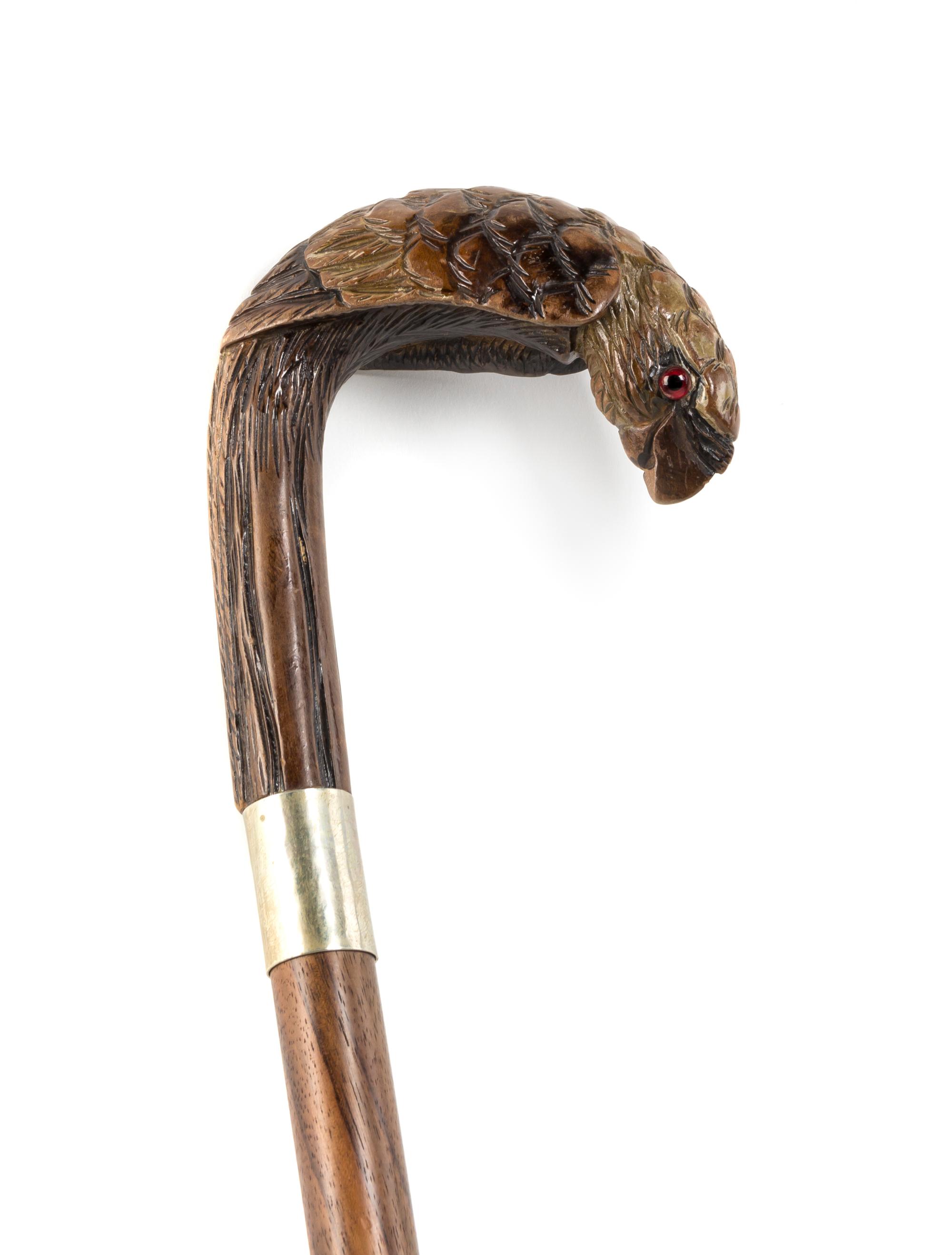 A Carved Wood Cane, Length of handle 5 1/4 x length overall 35 3/4 inches.