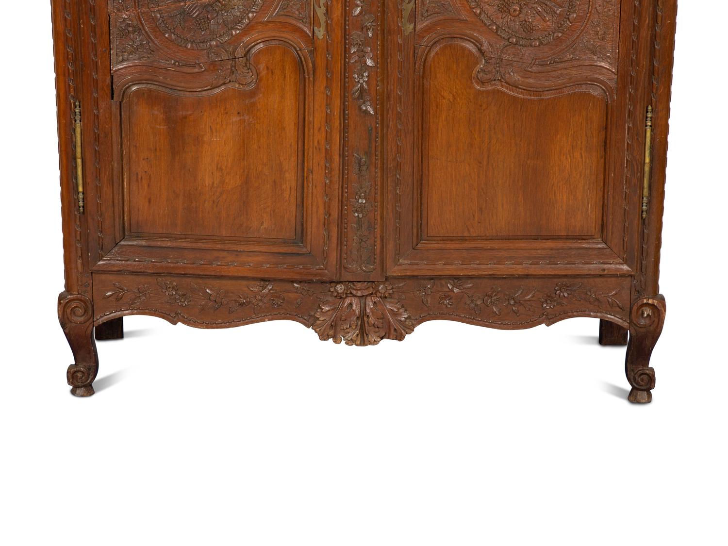 A French Provincial Carved Oak Armoire