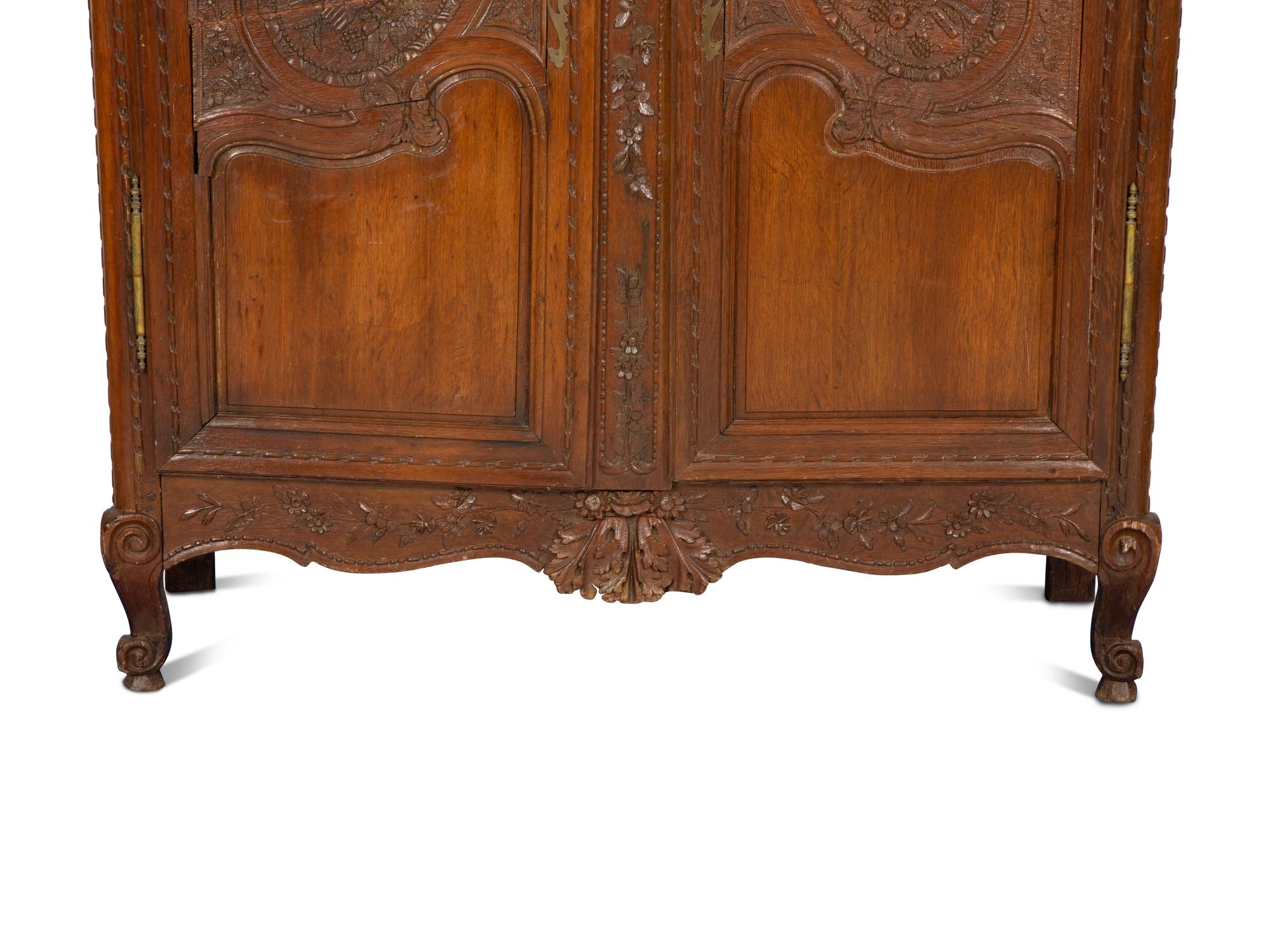 A French Provincial Carved Oak Armoire