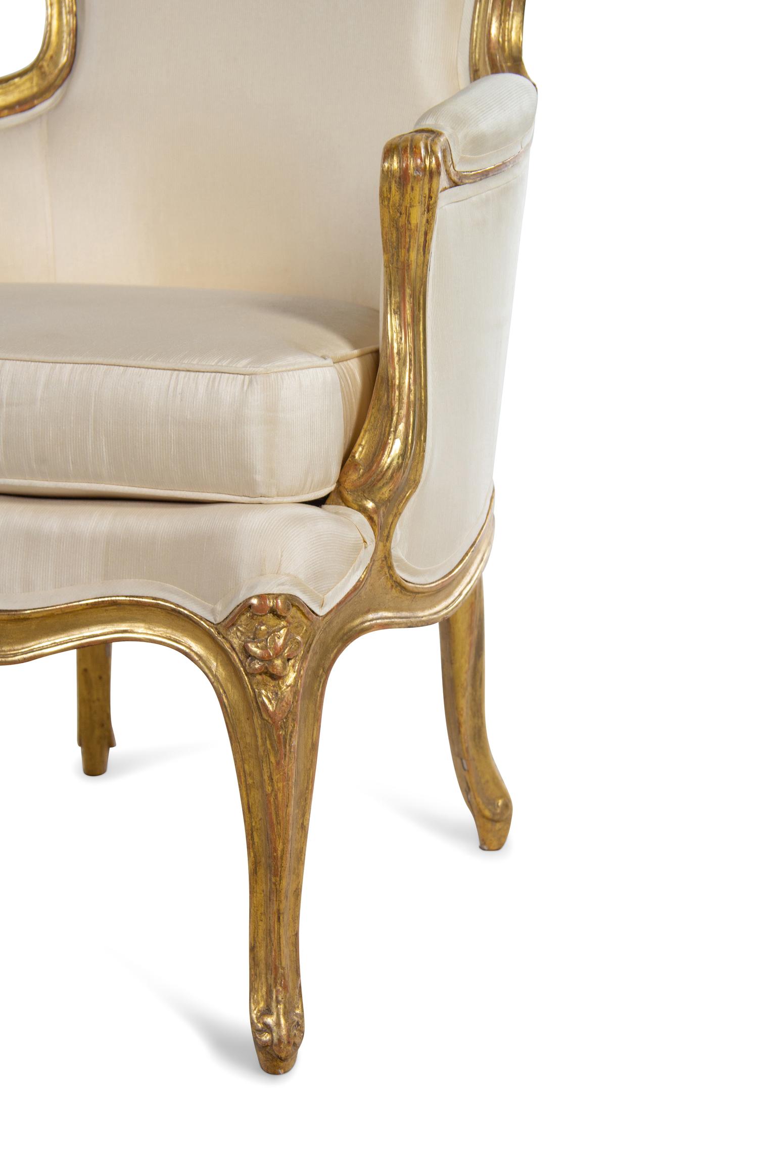 A Pair of Louis XV Carved Giltwood Bergères