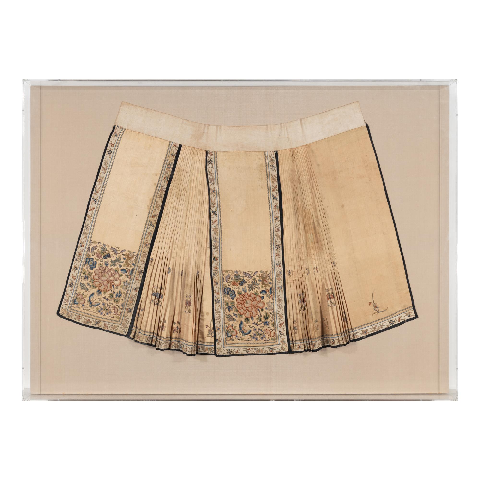A Chinese Apricot Ground Embroidered Silk Apron Skirt and A Blue Ground Embroidered Silk Hat, 19th Century — 晚清 杏色地繡牡丹紋馬面裙及藍底繡瓜果紋帽