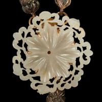 A Chinese carved reticulated greyish-white jade floraform applique The jade Qing dynasty or earlier